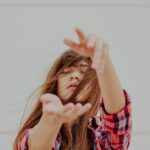 woman standing behind white background