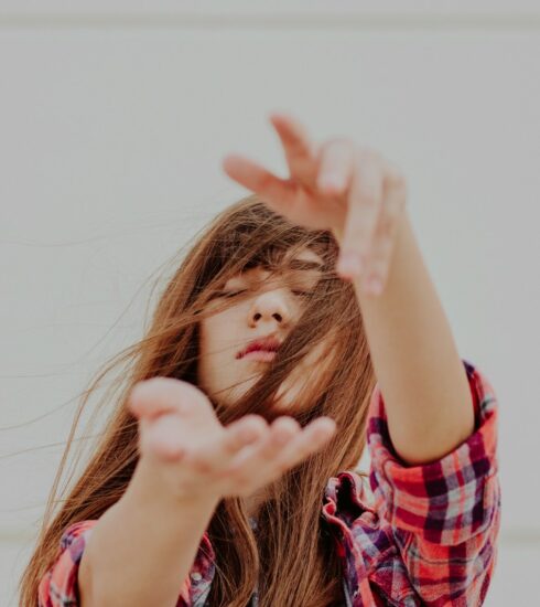 woman standing behind white background