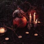 pumpkin between lighted candles