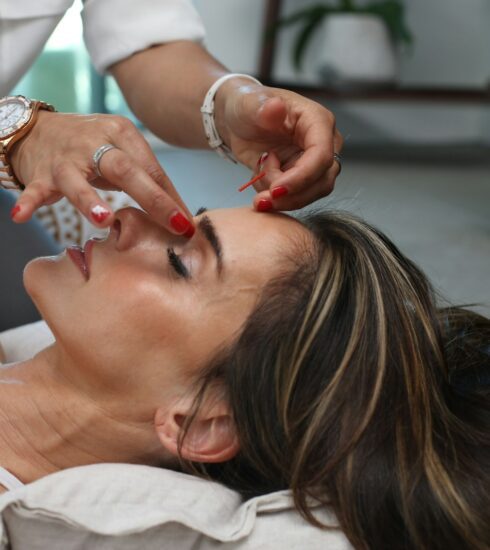 person holding woman nose